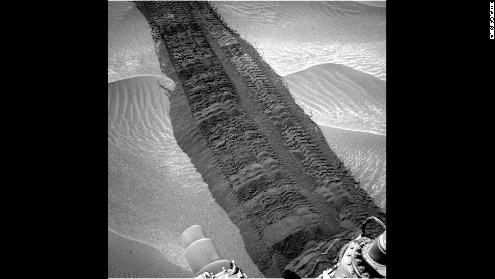 Wheel tracks from Curiosity are seen on the sandy floor of a lowland area dubbed &quot;Hidden Valley&quot; in this image.