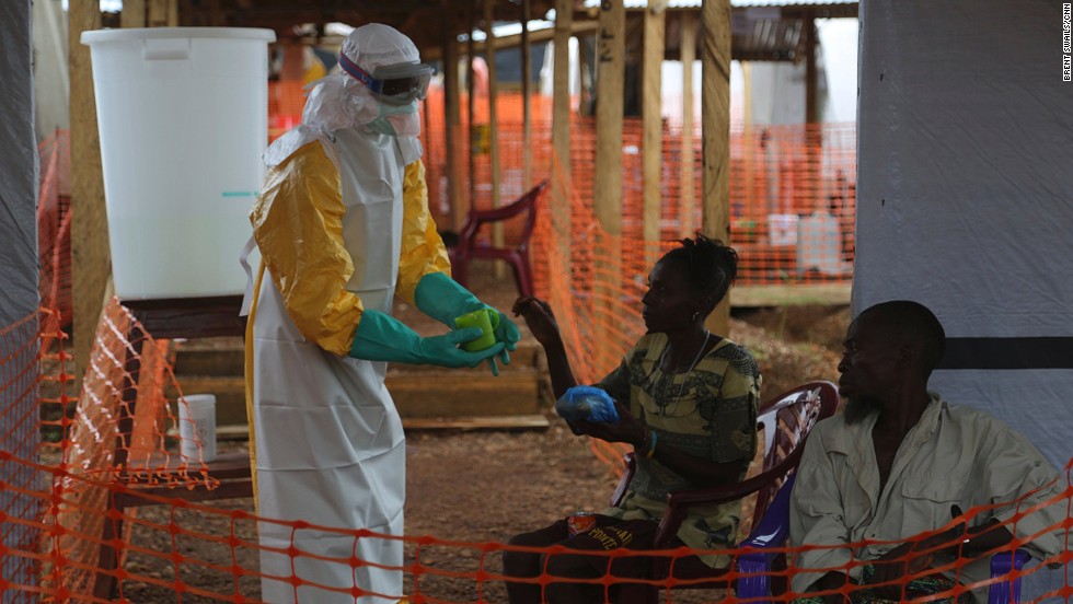 Lassa fever in the same family of viruses as the Ebola virus. Both diseases can cause haemorrhaging and can spread through contact with infected bodily fluids, though this is more rare with Lassa fever. Pictured, a healthworker gives food to confirmed Ebola patients.