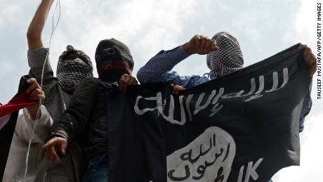 Kashmiri demonstrators hold up a flag of the Islamic State of Iraq and the Levant (ISIL) during a demonstration against Israeli military operations in Gaza, in downtown Srinagar on July 18, 2014. The death toll in Gaza hit 265 as Israel pressed a ground offensive on the 11th day of an assault aimed at stamping out rocket fire, medics said. AFP PHOTO/Tauseef MUSTAFA (Photo credit should read TAUSEEF MUSTAFA/AFP/Getty Images)