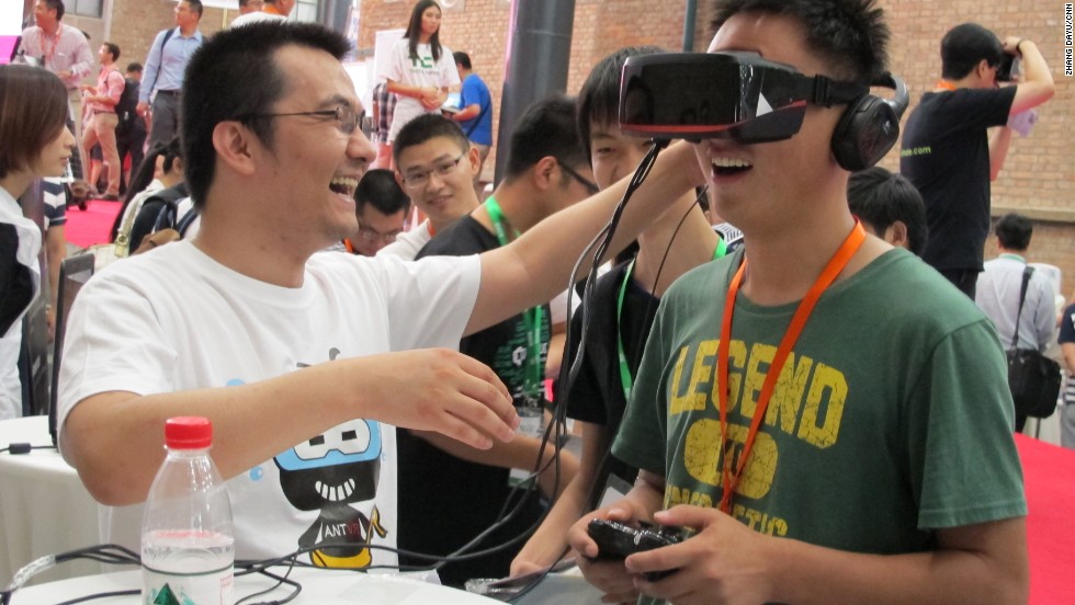 A visitor plays with a gaming helmet designed by Beijing-based company ANTVR. The device allows its user to fully immerse themselves in the virtual experience.