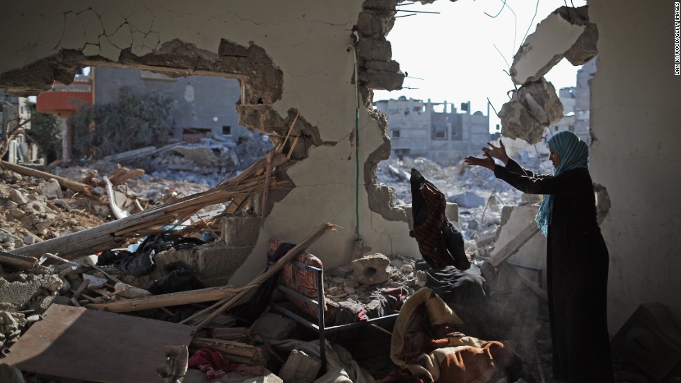 Islam El Masri begins to sort through the rubble of her destroyed home in Beit Hanoun, Gaza, on Thursday, August 14.