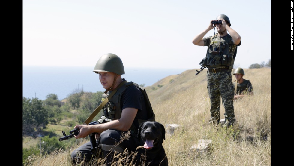 Ukrainian border guards patrol near Novoazovsk on Friday, August 15.