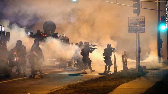 Police attempt to control protesters in the streets of Ferguson, Missouri, on Monday, August 18.