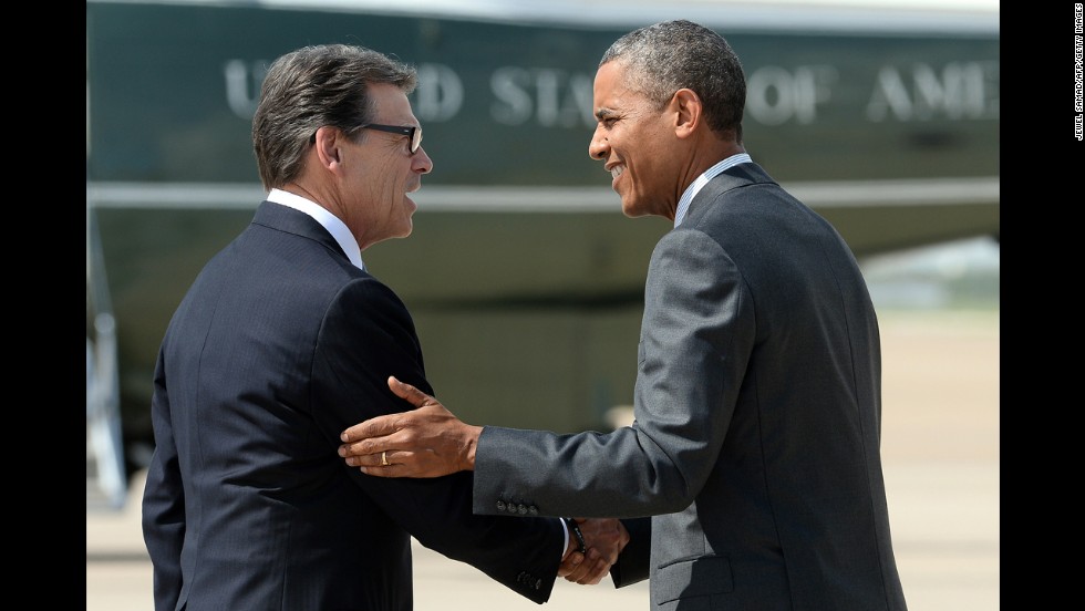 Perry greets President Barack Obama as he arrives in Dallas on July 9, 2014, for a meeting with local elected officials and faith leaders about the humanitarian situation at the Southwest border.