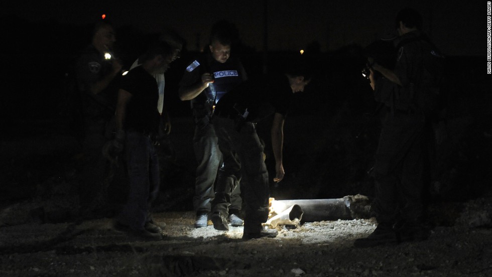 Police examine the remains of a rocket launched from Gaza that landed near the kibbutz of Yad Mordechay on August 19.
