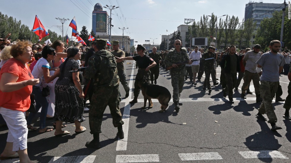 People yell as Ukrainian prisoners are paraded through Donetsk in eastern Ukraine on August 24. 