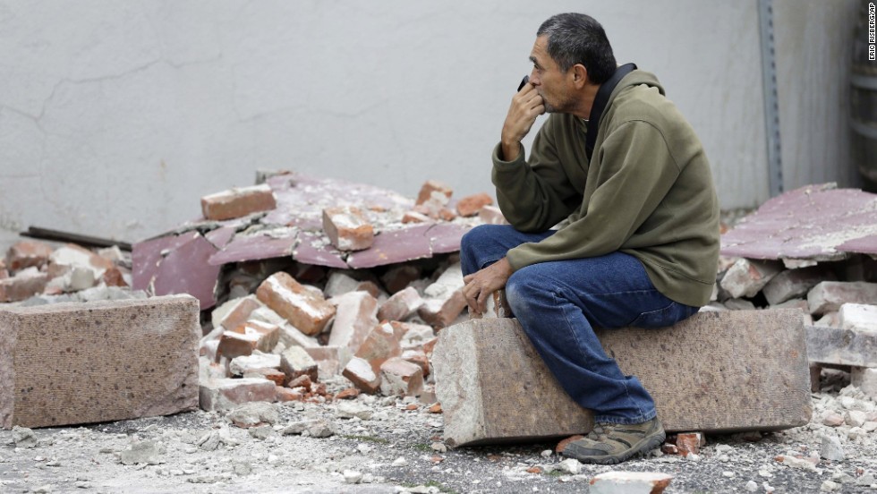 Ron Peralez sits on rubble and looks at damaged buildings on Monday, August 25, in Napa, California. The San Francisco Bay Area&#39;s strongest earthquake in 25 years struck the heart of California&#39;s wine country on August 24.