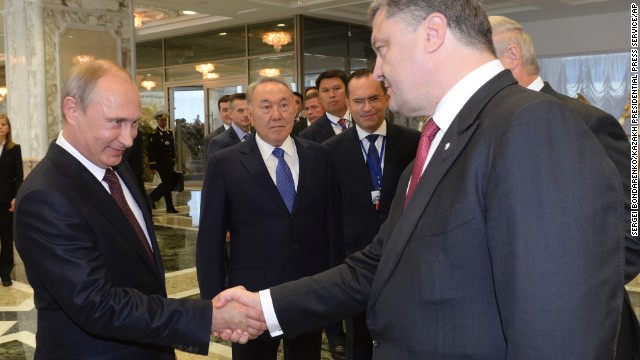 Presidents Vladimir Putin and Petro Poroshenko shake hands after talks in Belarus on Tuesday.