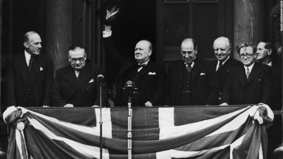 British Prime Minister Winston Churchill addresses the celebrating crowds from the balcony of the Ministry of Health in Whitehall, London, on V-E Day, May 8, 1945. The war in Europe was officially over.