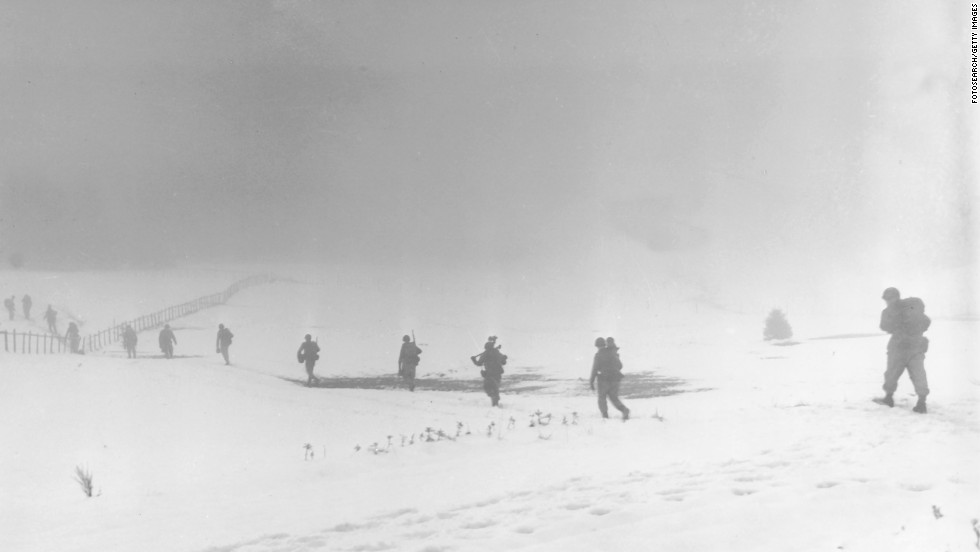 Soldiers of an infantry division move into the mist over a snow-covered field near Krinkelter, Belgium, on December 20, 1944, during the Battle of the Bulge, a surprise German counter-offensive against Allied forces as they closed in on German soil from the west. It resulted in more combined U.S. losses (nearly 90,000 killed, wounded or captured) than any battle of the war.