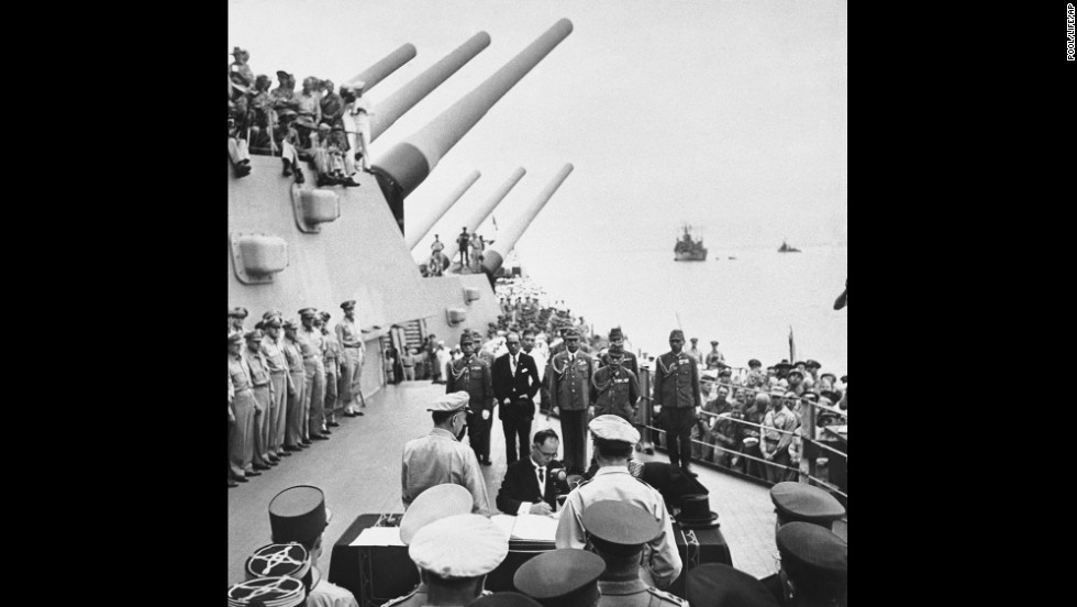 Japanese Foreign Minister Mamoru Shigemitsu signs the Japanese Instrument of Surrender on the deck of the battleship USS Missouri in Tokyo Bay on September 2, 1945, officially bringing World War II to an end. Overseeing the surrender is U.S. Gen. Douglas McArthur (right, back to camera).