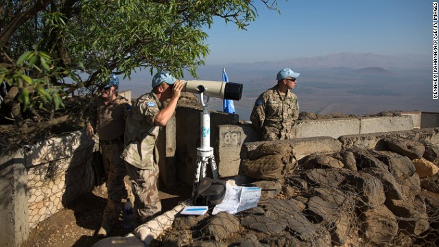U.N. Disengagement Observer Force troops watch the Syrian side of the Golan Heights at Mount Bental in late August. 