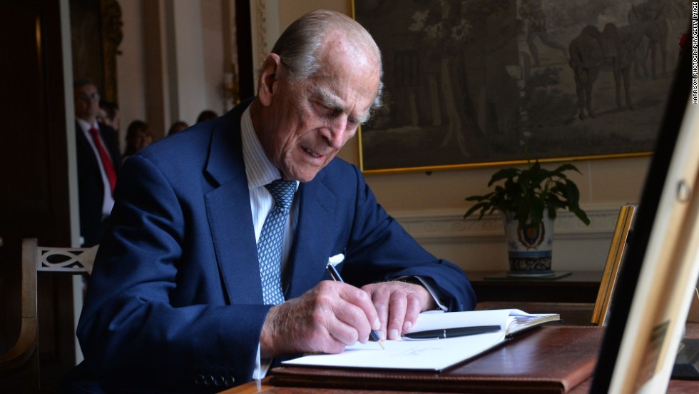 Prince Philip signs the guest book at Hillsborough Castle in Belfast, Northern Ireland, in June 2014.