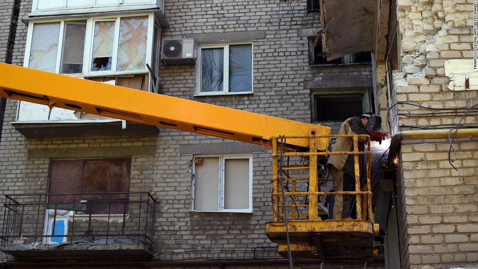 A man repairs damage to a building caused by shelling in Donetsk on September 5. 