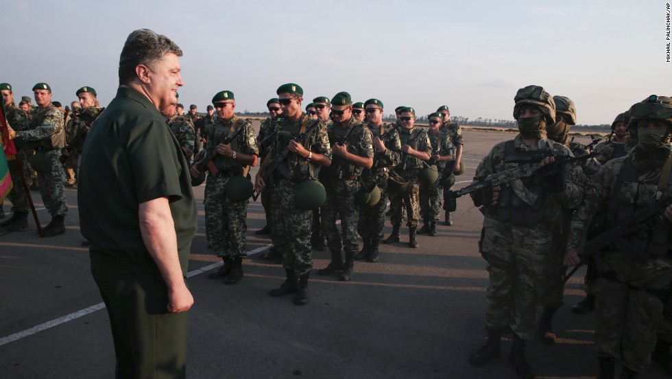 Ukrainian President Petro Poroshenko, left, inspects military personnel during a visit to Mariupol on Monday, September 8.