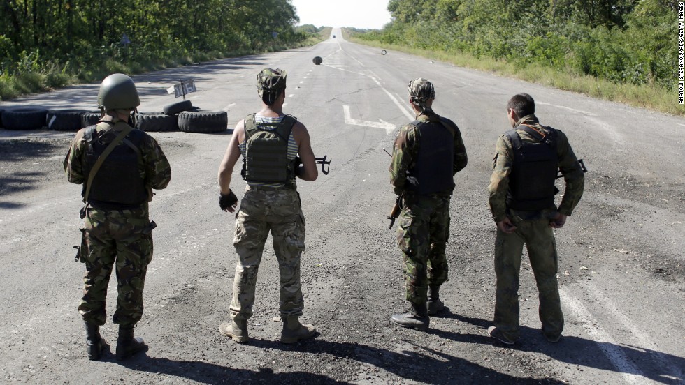 Ukrainian troops stand on a deserted road as they patrol the border area of the Donetsk and Luhansk regions Friday, September 5, near Debaltseve.