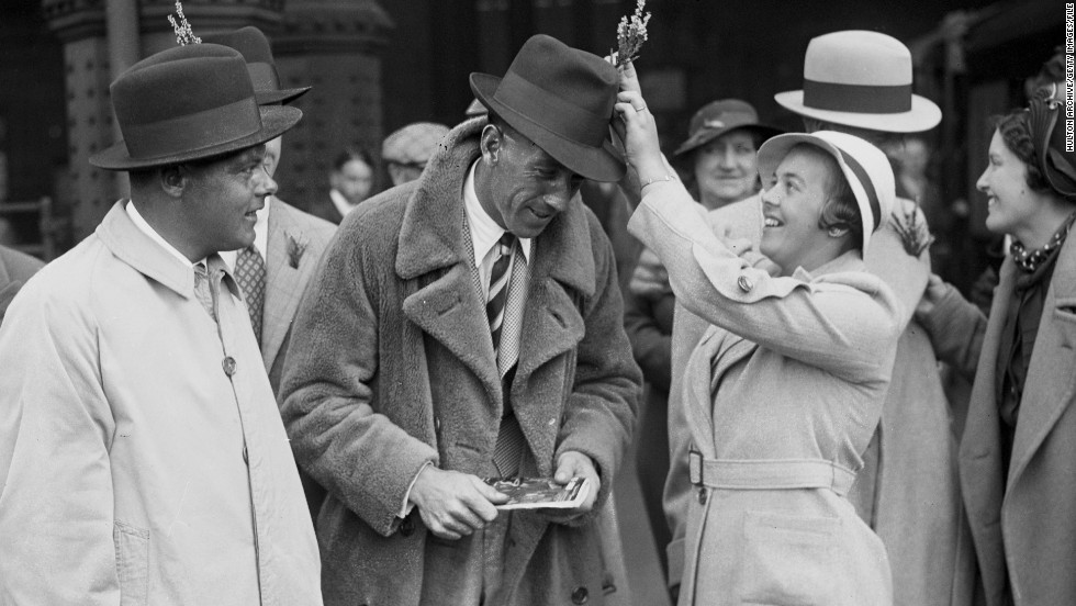Players&#39; wives and girlfriends have always been a part of the Ryder Cup, but their role has become more prominent as time has gone on. Here, Alf Padgham&#39;s wife lodges a sprig of lucky heather in her husband&#39;s hat at Waterloo station in London before the Great Britain team departed for the 1935 Ryder Cup in New Jersey.