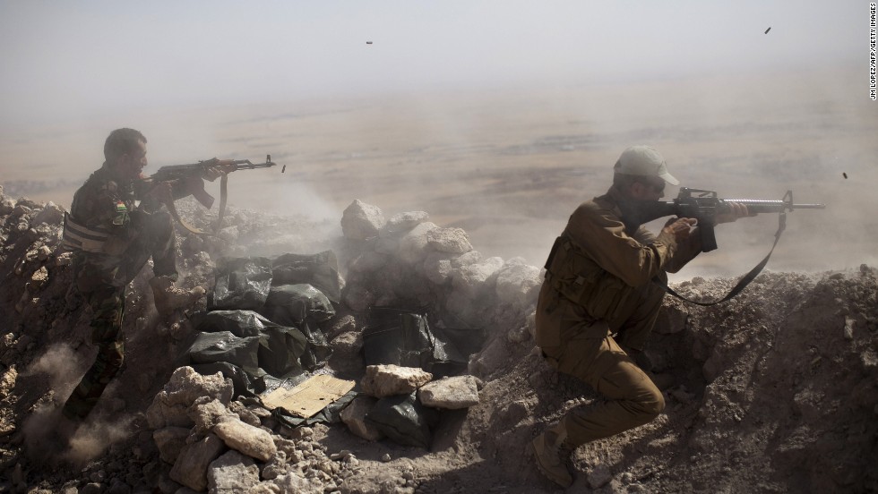 Kurdish Peshmerga fighters fire at ISIS militant positions from their position on the top of Mount Zardak, east of Mosul, Iraq, on Tuesday, September 9. 