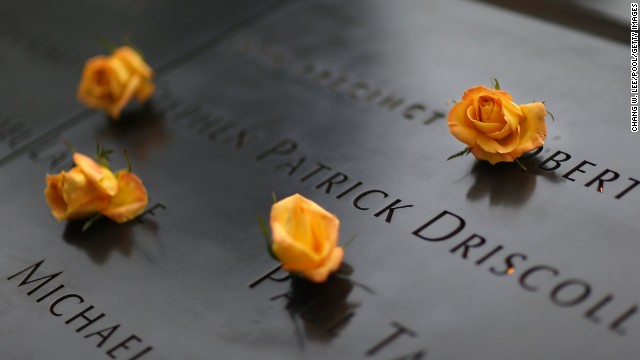 Flowers are placed over names of vicitims of September 11, 2001 at the South Tower Memorial Pool before memorial observances are held at the site of the World Trade Center on September 11, 2014 in New York City. 