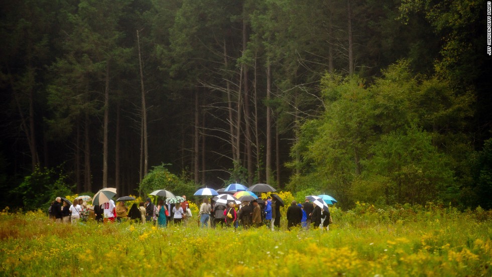 Family members gather in the rain at the impact site in Shanksville.