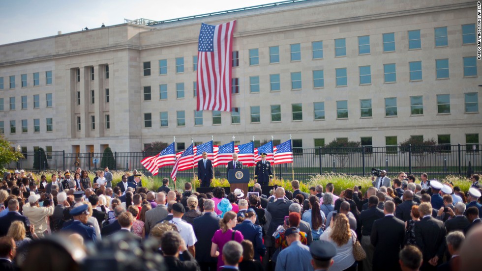 From left, U.S. President Barack Obama, U.S. Defense Secretary Chuck Hagel and Chairman of the Joint Chiefs of Staff Gen. Martin Dempsey stand on stage as they participate in a ceremony at the Pentagon.