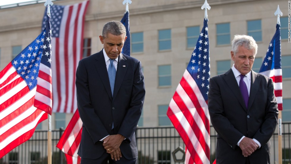 Obama and Hagel bow their heads during the ceremony at the Pentagon.