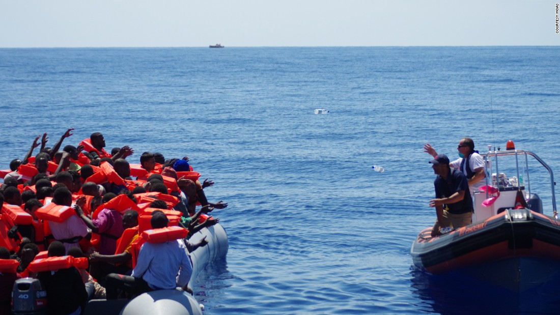 A lifeboat from rescue ship &quot;Phoenix&quot; approaches refugees, offering drinking water. &quot;We never approach a boat with our boat because it&#39;s rather big, so we approach cautiously with a dingy. The first thing we do is start giving out life jackets,&quot; said MOAS director Martin Xuereb.