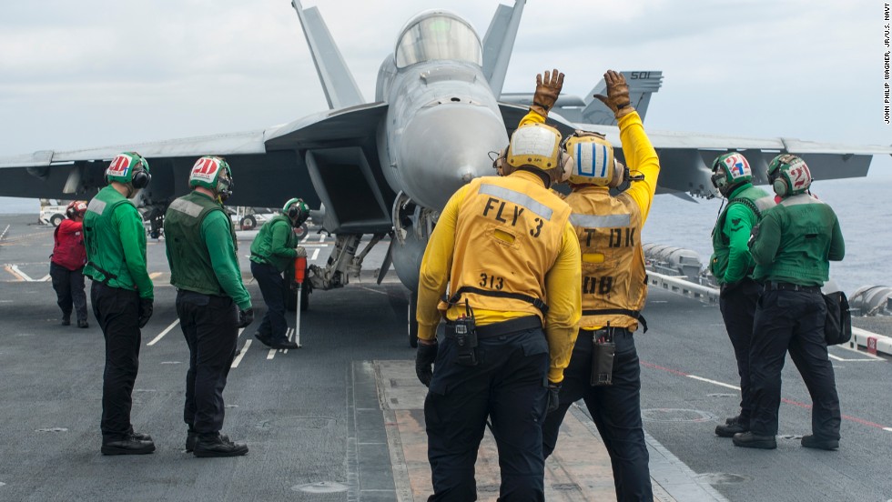 An F/A-18E Super Hornet from the Sunliners of Strike Fighter Squadron 81 taxis onto a catapult before launching from the flight deck of the aircraft carrier USS Carl Vinson.