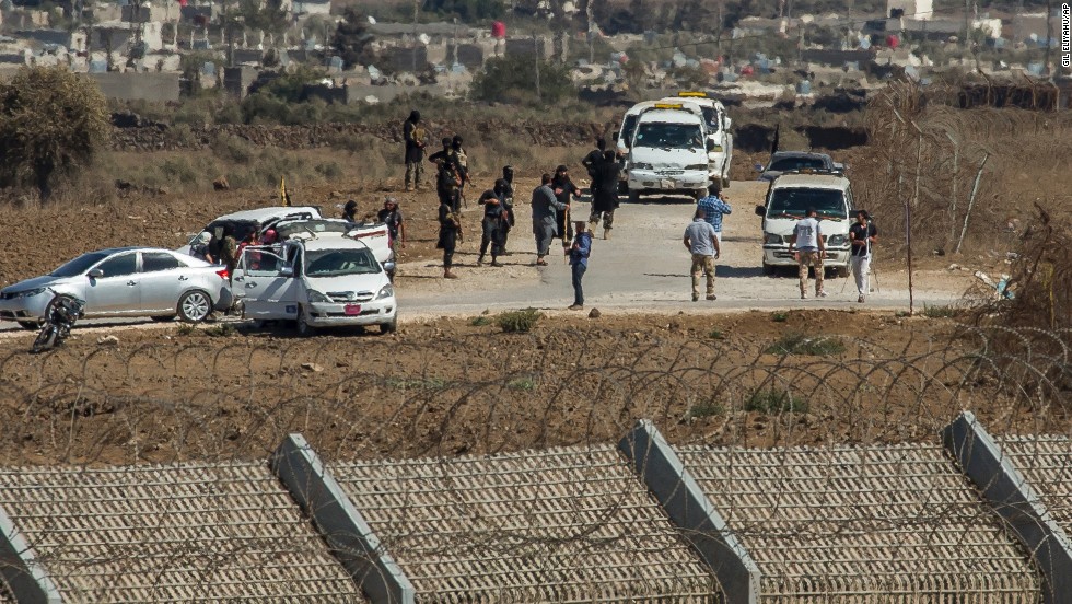 Al-Qaeda-linked rebels from Syria gather around vehicles carrying U.N. peacekeepers from Fiji before releasing them Thursday, September 11, in the Golan Heights. The 45 &lt;a href=&quot;http://www.cnn.com/2014/09/01/world/meast/syria-crisis/index.html&quot; target=&quot;_blank&quot;&gt;peacekeepers were captured &lt;/a&gt;in the Golan Heights after rebels seized control of a border crossing between Syria and the Israeli-occupied territory.