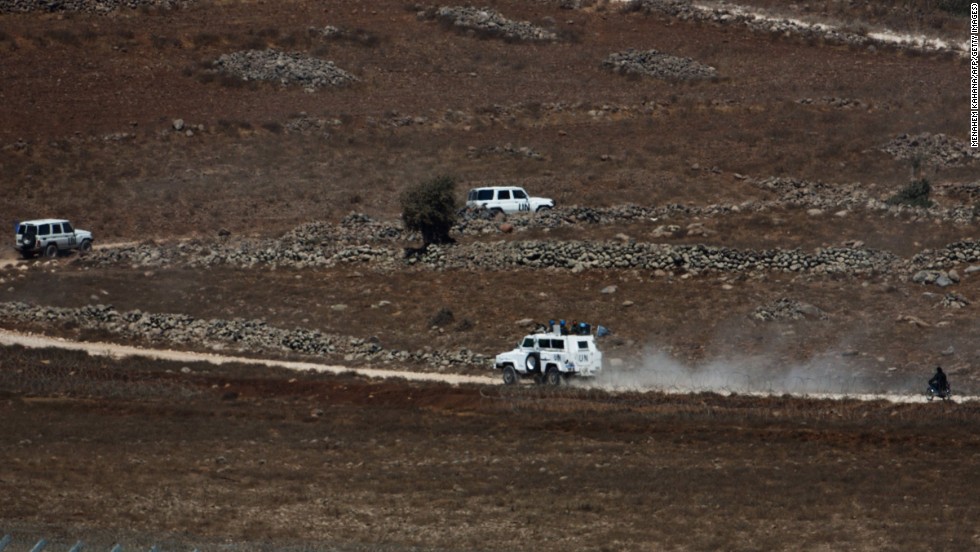 A U.N. convoy moves in the buffer zone near the Golan Heights as they are escorted by Syrian rebel fighters near the Syrian village of Jubata Al Khashab on Tuesday, September 2.