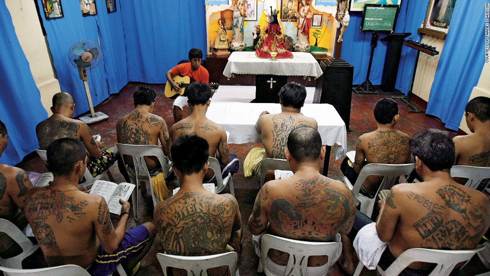 Inmates of the Makati City jail in Manila attend Catholic worship in 2010. Their tattoos identify them as members of particular gangs.