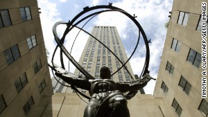 NEW YORK, UNITED STATES:  This 28 April, 2005 photo shows the statue of Atlas in front of Rockefeller Center in midtown New York City. two ton statue of Atlas is the largest sculptural work at Rockefeller Center. Atlas carries the heavens upon his shoulders as punishment for defying Zeus. Designed and cast in 1936 by Lee Lawrie and Rene Chambellan, the statue's exaggerated musculature and stylized body are characteristic of the Art Deco style. AFP PHOTO / Timothy A. CLARY  (Photo credit should read )