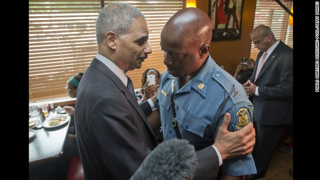 U.S. Attorney General Eric Holder talks with Capt. Ron Johnson, right, of the Missouri State Highway Patrol on August 20, 2014 in Ferguson, Missouri.