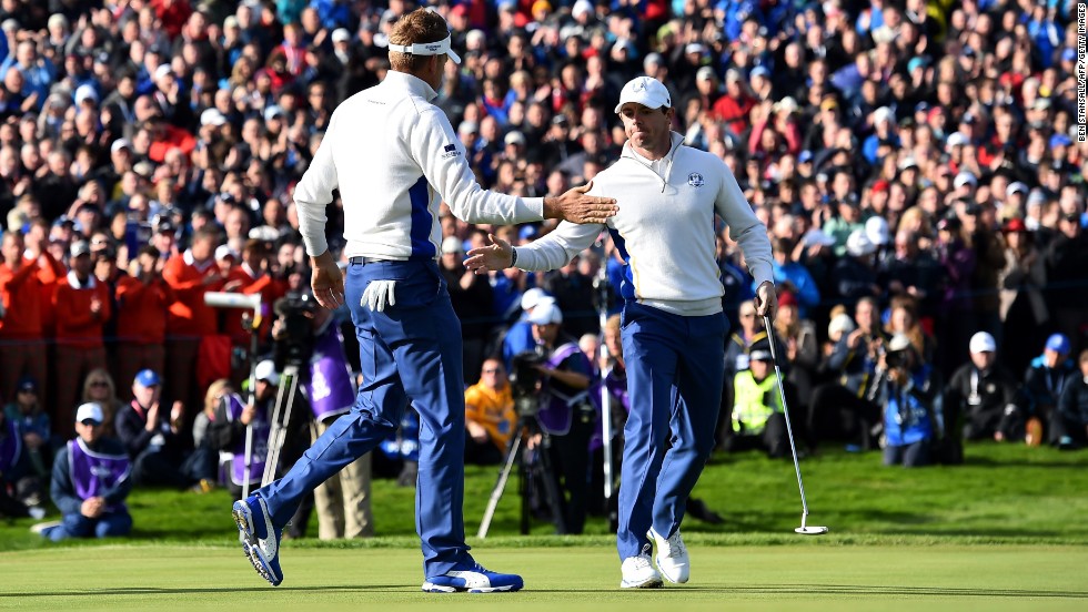 Europe&#39;s Rory McIlroy (right) and Ian Poulter claimed a vital half point against Jimmy Walker and Rickie Fowler in the morning fourballs on Saturday.