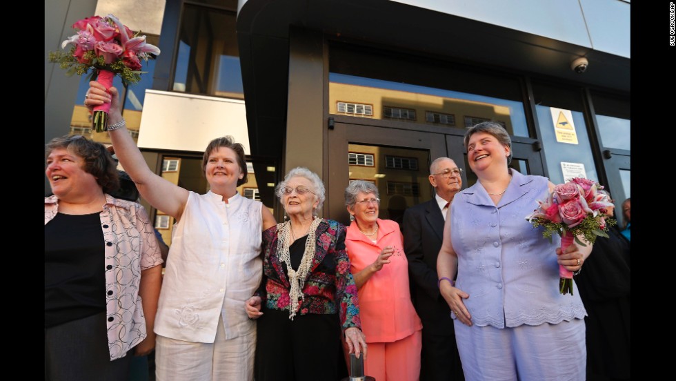 Mary Bishop, second from left, and Sharon Baldwin, right, celebrate with family and friends following their wedding ceremony on the courthouse steps in Tulsa, Oklahoma, on October 6, 2014.