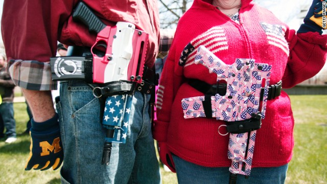  A couple at a Michigan open-carry gun rally celebrates America and the right to bear arms.