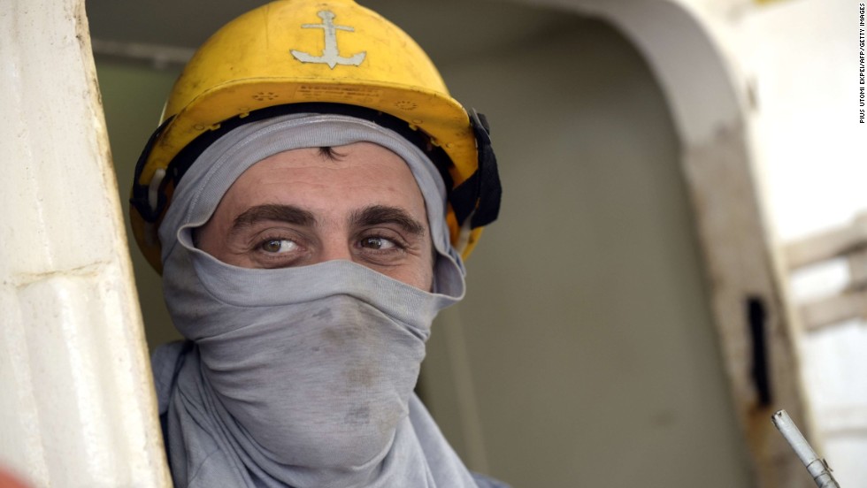 Here, a Ukrainian sailor uses a T-shirt as a face mask as he watches Nigerian health workers check the ship he&#39;s on for signs of the Ebola virus. The World Health Organization, or WHO, recommends a medical mask to adequately protect the mouth and nose.