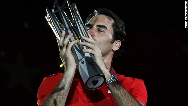 Sealed with a kiss: Roger Federer wins his first Shanghai Masters and fourth title of the 2014 season
