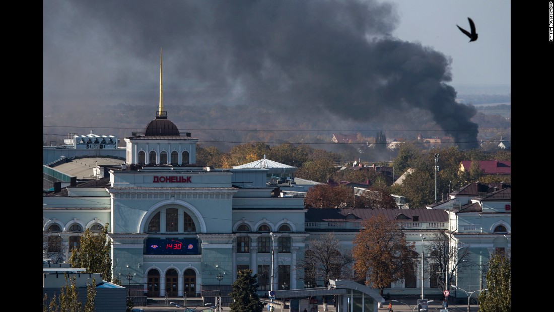 Smoke rises behind the train station in Donetsk, Ukraine, during an artillery battle between pro-Russian rebels and Ukrainian government forces on Sunday, October 12.