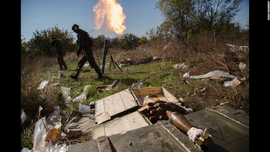 Pro-Russian rebels fire mortars toward Ukrainian positions near to the Donetsk airport on October 8.