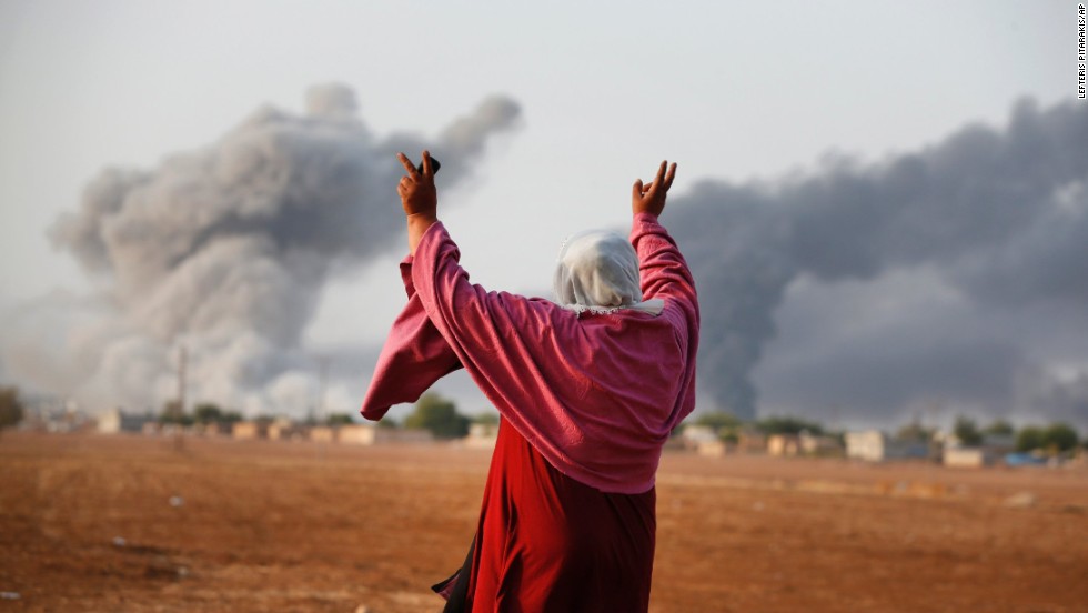 Kiymet Ergun, a Syrian Kurd, celebrates in Mursitpinar, Turkey, after an airstrike by the U.S.-led coalition in Kobani on Monday, October 13.