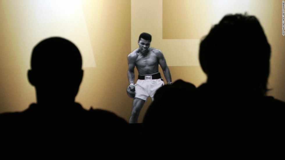 Members of the media watch a video of Ali before the grand opening of the Muhammad Ali Center in Louisville, Kentucky, in November 2005. 