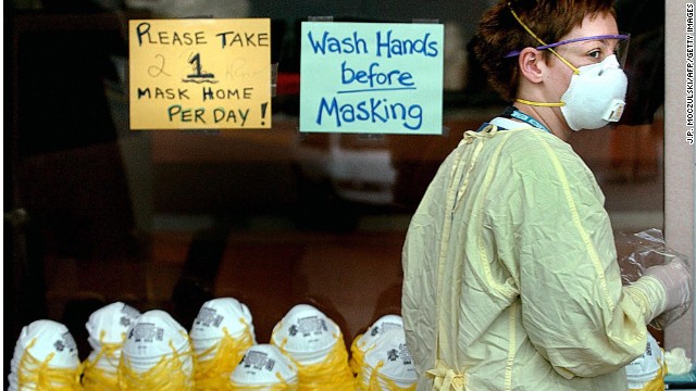 A health worker wears a surgical mask, goggles, gown and gloves to protect against SARS at a Toronto hospital in May 2003.