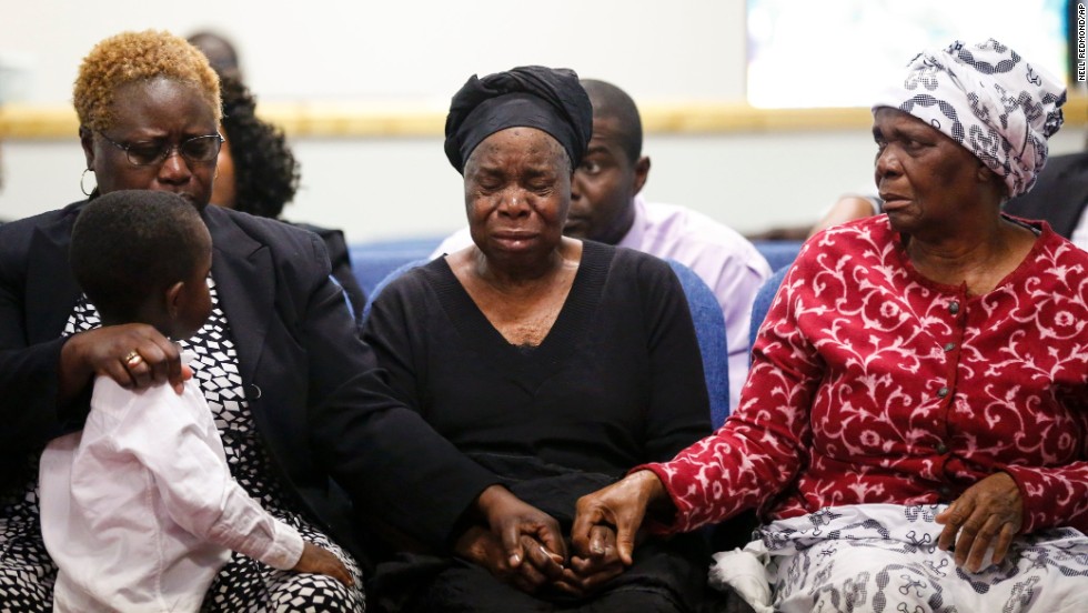 Garteh Korkoryah, center, is comforted during a memorial service for her son, Thomas Eric Duncan, on October 18, 2014, in Salisbury, North Carolina. Duncan, a 42-year-old Liberian citizen, died October 8 in a Dallas hospital. He was in the country to visit his son and his son&#39;s mother, and he was the first person in the United States to be diagnosed with Ebola.