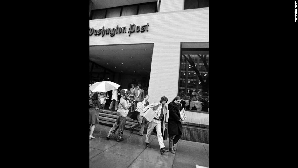 Bernstein, left, and Woodward, along with other editorial employees, walk off the job at the Post in Washington, April 8, 1974, after the local arm of the American Newspaper Guild went on strike against the paper. 