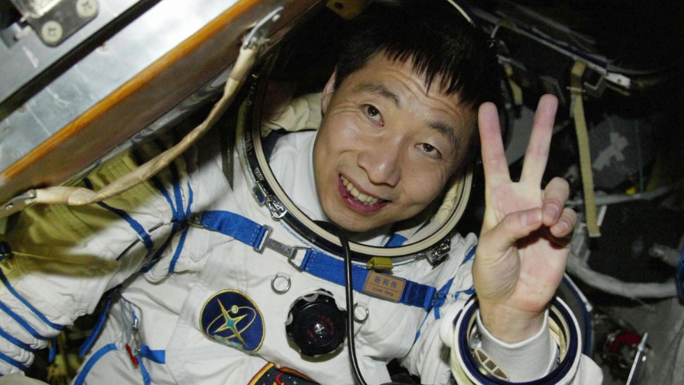 Chinese astronaut Yang Liwei waves from the Shenzhou V capsule after completing China&#39;s first manned space flight in 2003.