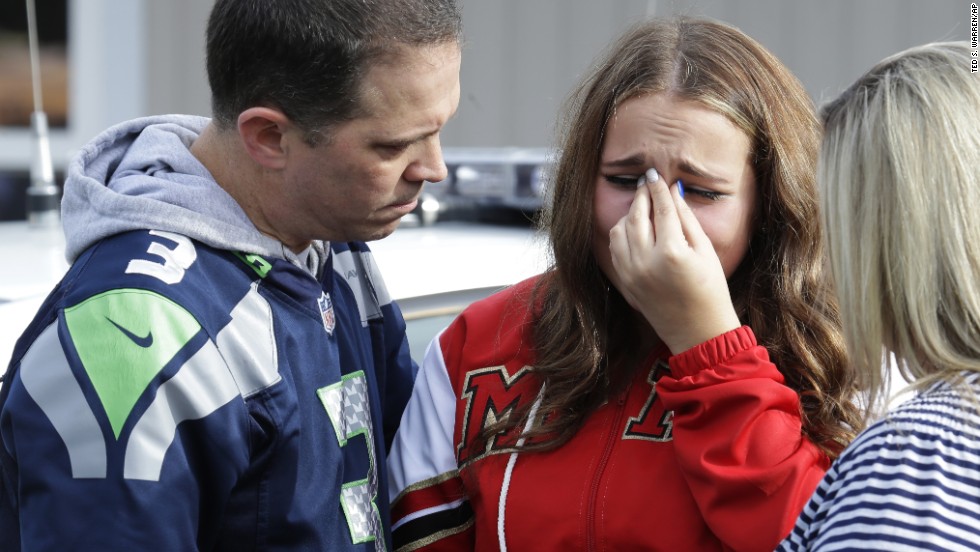 A girl is consoled at the church after the shooting.