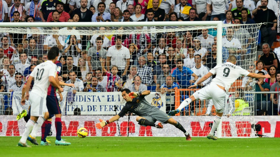 Benzema (right) slides his shot past Cladio Bravo to score Real Madrid&#39;s third goal against Barcelona in  a 3-1 win at the Bernabeu in October 2014.