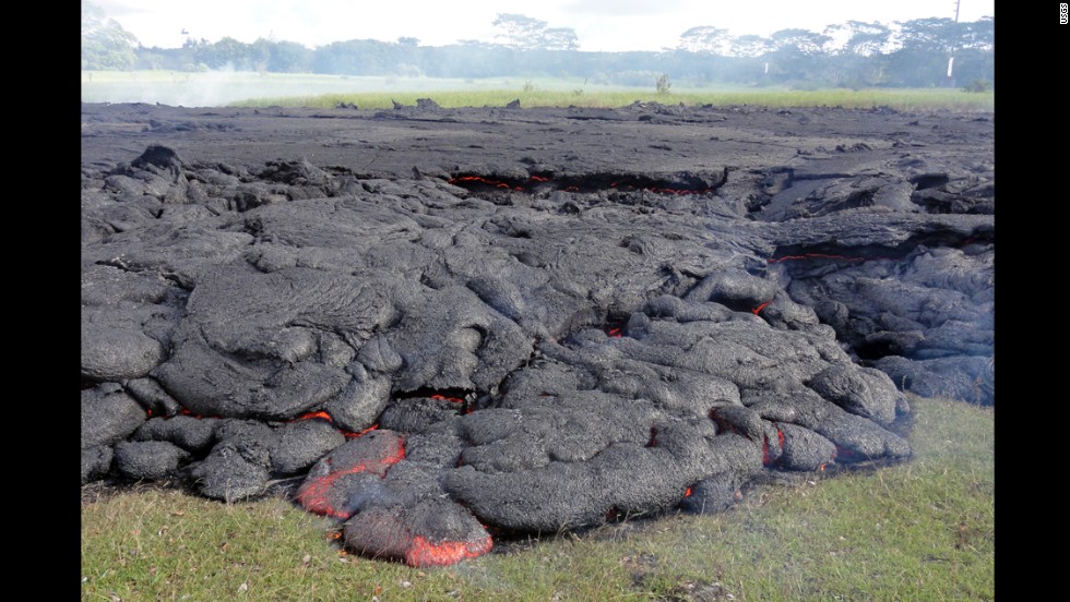 The horizontal incandescent cracks seen in the center and right portions of the photo, taken October 25, indicate that the flow was inflating: Fed by a continuing supply of lava beneath the cooling crust, the surface slowly rises.