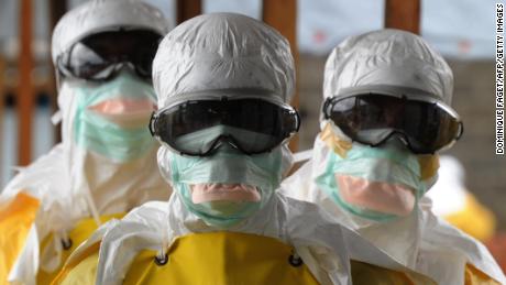 Health care workers, wearing protective suits, leave a high-risk area at the French NGO Medecins Sans Frontieres (Doctors without borders) Elwa hospital on August 30, 2014 in Monrovia. Liberia was hardest-hit by the Ebola virus when it raged through west Africa